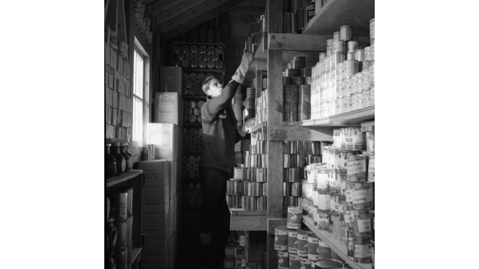 A G Lewis in store room, Port Lockroy